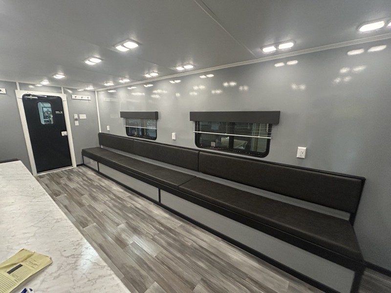 bench seating and tables inside the break room trailer